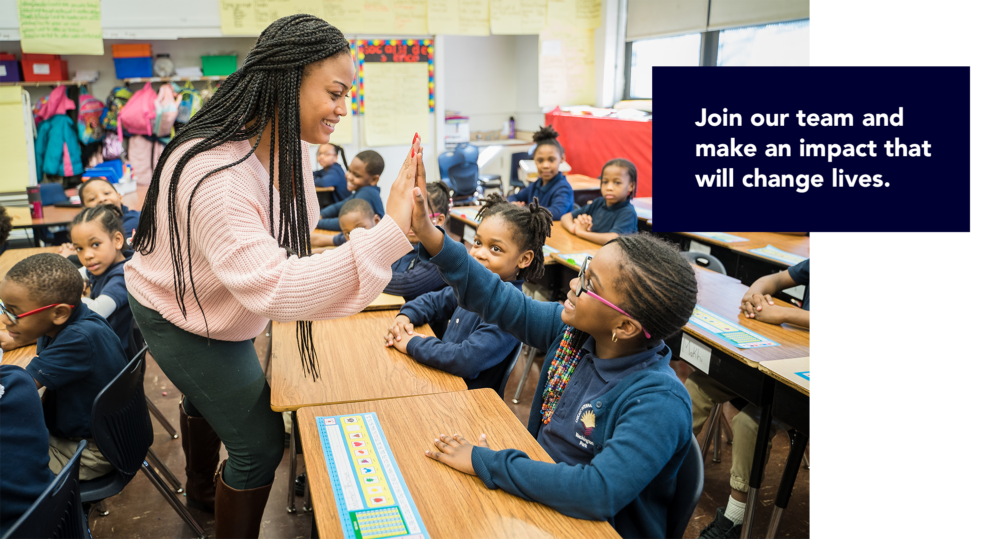 Join our team and make an impact that will change lives. Teacher giving student a high five.