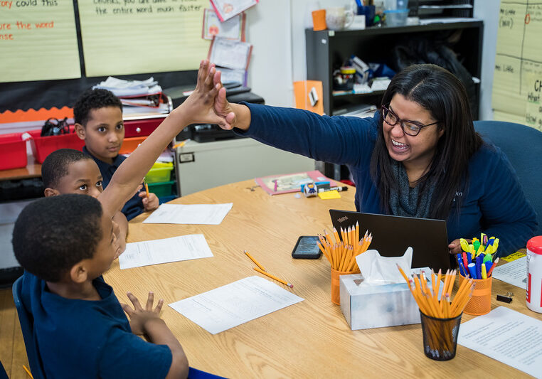 CICS Avalon teacher giving high five to her students in Chicago, Illinois
